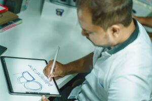 Designer sketching a brand identity concept on a tablet