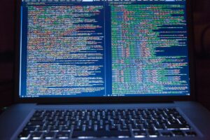 Laptop screen showing software code during a system update