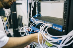 IT engineer fixing network cables on a server rack
