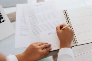 Hands signing a software licence renewal agreement